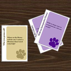Image of a gold question card and two purple answer cards.